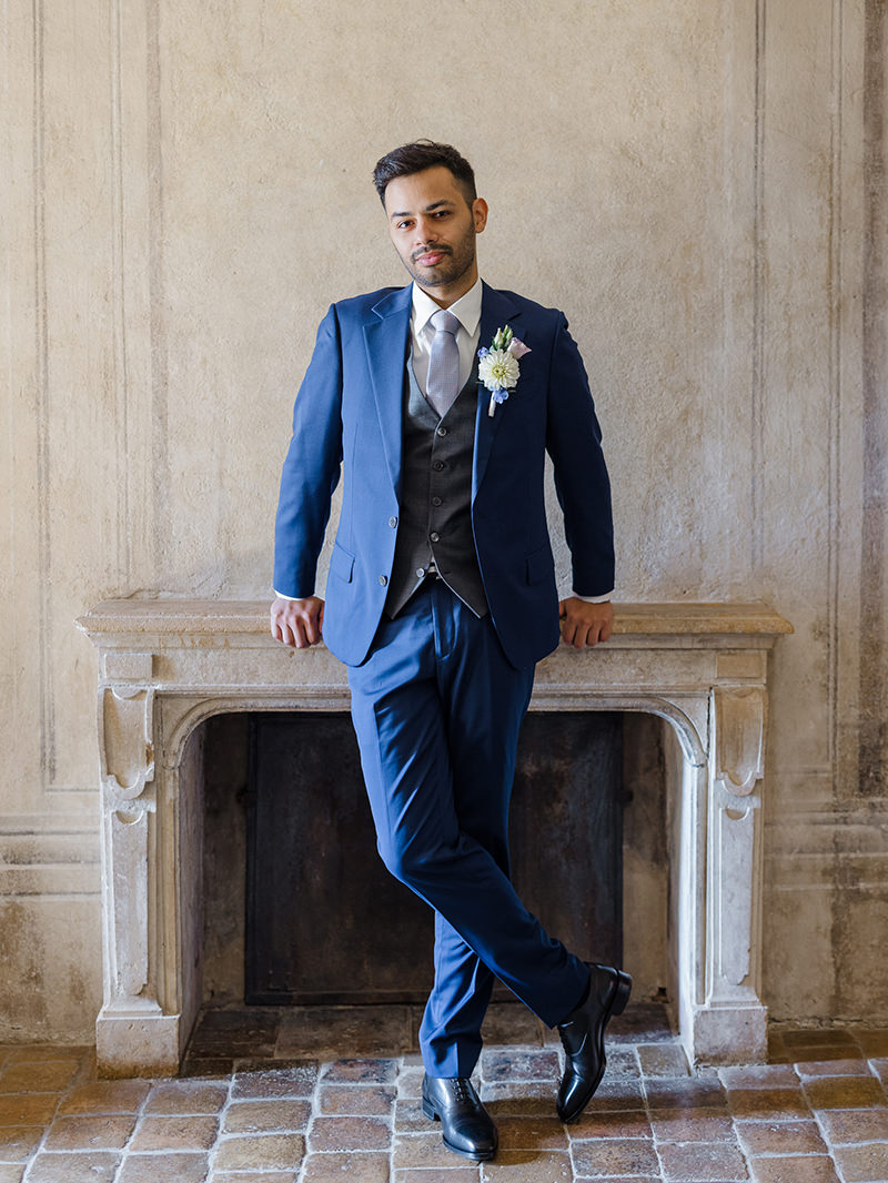 0021-chateau-de-bagnols-wedding-france-groom-portrait-historic-interior