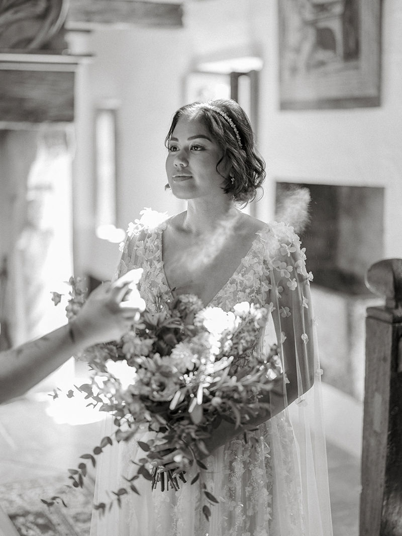0023-chateau-de-bagnols-wedding-france-bride-holding-blue-bouquet-black-white