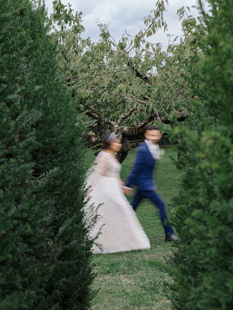 0112-chateau-de-bagnols-wedding-france-bride-groom-garden-motion-portrait